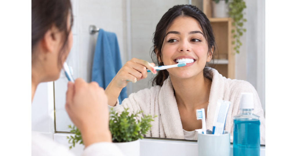 Woman brushing her teeth to improve dental hygiene habits